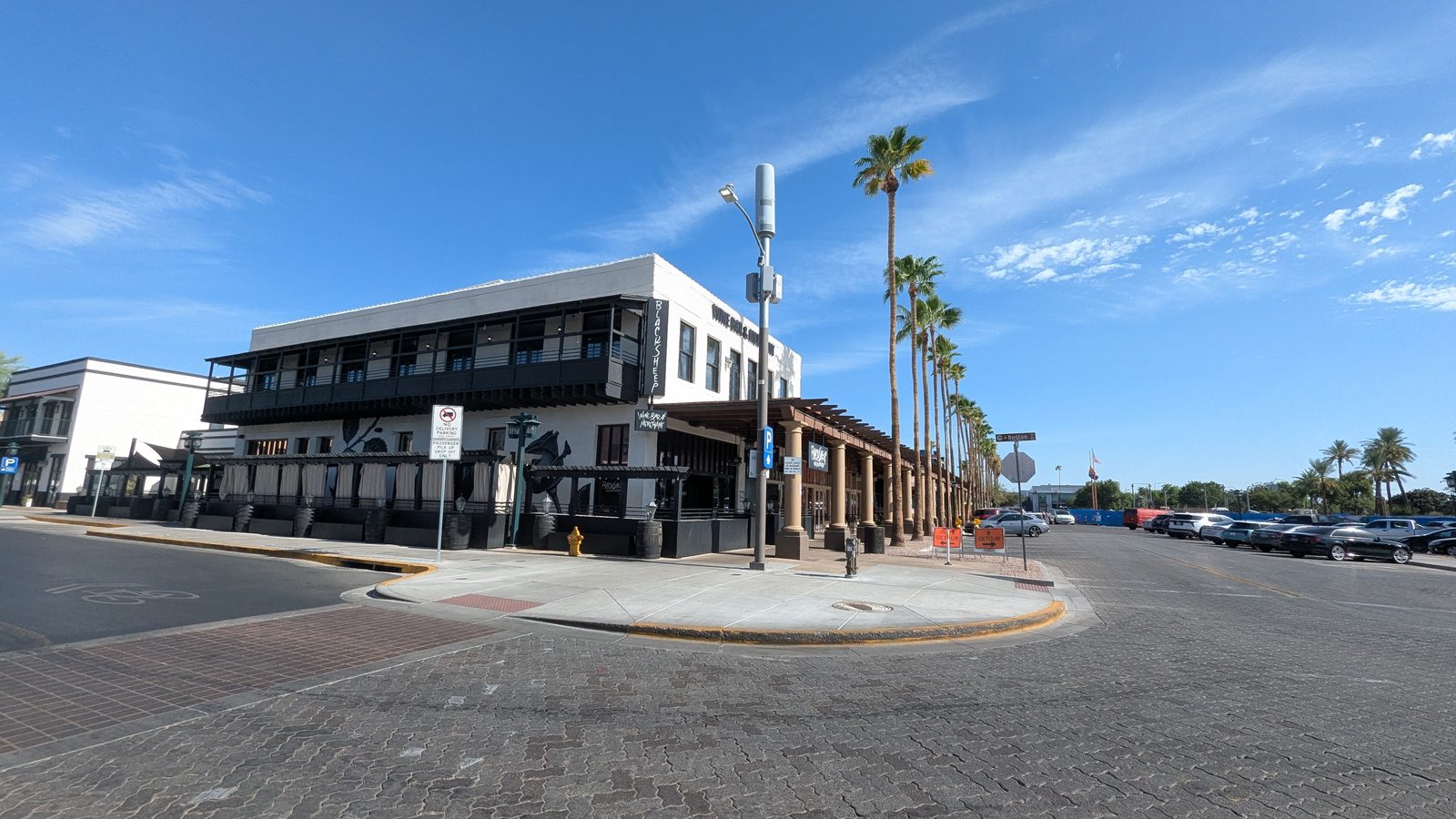 View toward the Crowne Plaza restaurant patios along a palm-lined walk